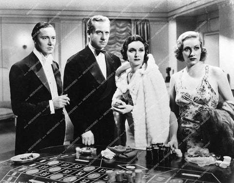 Melvyn Douglas, Gail Patrick, Tala Birell, Henry Mollison at the roulette table - 1935 film The Lone Wolf Returns - 0449-036