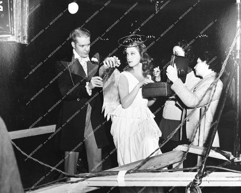 Jeanette MacDonald gets her wings adjusted by Nelson Eddy behind the scenes - 1942 film I Married an Angel - 0453-020