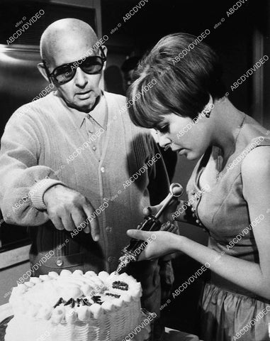 director Norman Taurog surpervises Deborah Walley decorating birthday cake - 11014-004