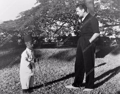 candid Errol Flynn with native pygmy on set film Kim 142-34