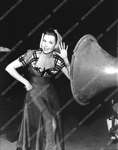 Ann Miller listening at the loud speaker 798-23