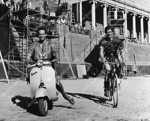 Charlton Heston Stephen Boyd on bikes and scooters on set film Ben-Hur 944-34