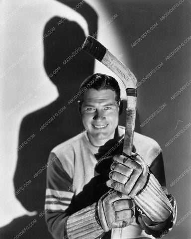 handsome Richard Arlen poses for a portrait in his hockey gear 1324-08