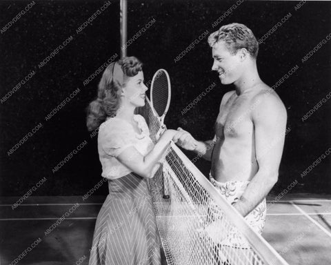 candid Shirley Temple and handsome shirtless Guy Madison playing tennis 1324-22
