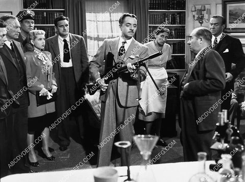 William Powell demonstrates machine gun to Ed Brophy film The Thin Man Goes Home 1960-03