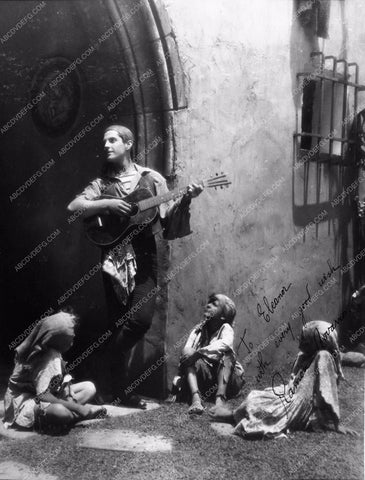 Ramon Novarro playing guitar for kids 2126-35