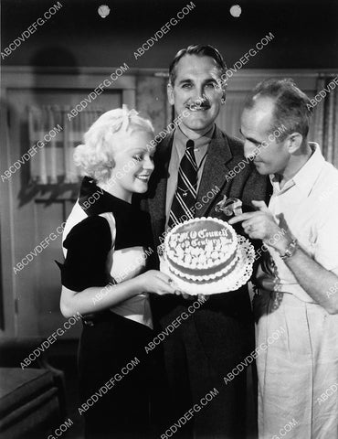 candid Alice Faye gives George Marshall a birthday cake 2334-29