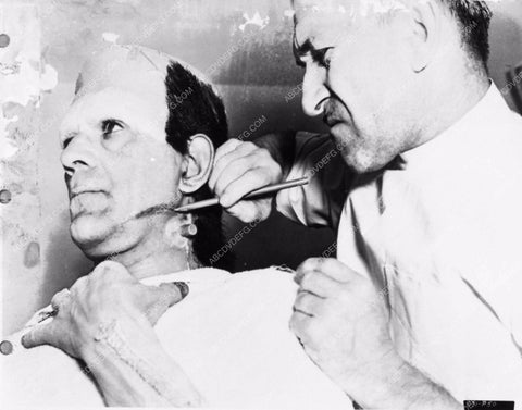 Jack Pierce applying Boris Karloff's Frankenstein makeup behind the sc 2706-29