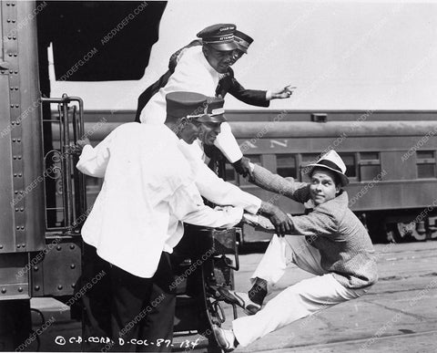 Arthur Lake hanging from back of train Blondie Plays Cupid 2890-29