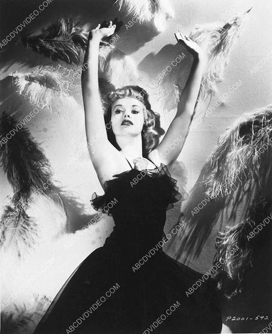 Betty Grable in front of wall of flowers 3030-06