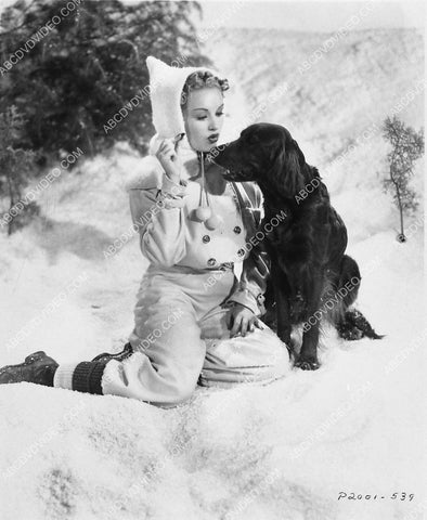 Betty Grable plays w her dog in the snow 3030-13