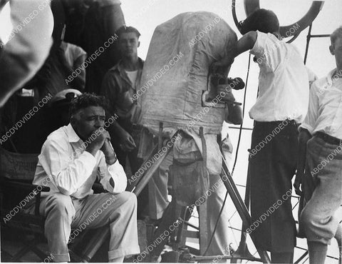director Clarence Brown sitting next to old movie camera at MGM Studios 3363-14