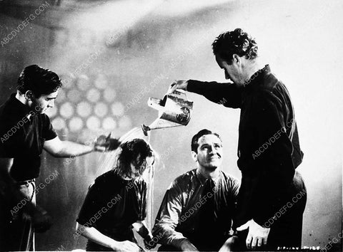 William Wellman pouring water on Carole Lombard for shot film Nothing Sacred 3490-35
