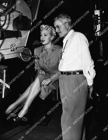 Lana Turner sits at the camera while cinematographer Ray June looks on 3517-30