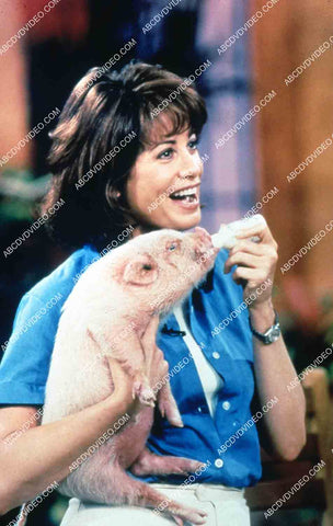 Brianne Leary giving piglett milk bottle Animal Planet documentary TV Petsburgh USA 35m-15918