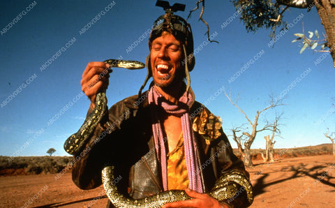 Bruce Spence with his snake filmThe Road Warrior 35m-3218