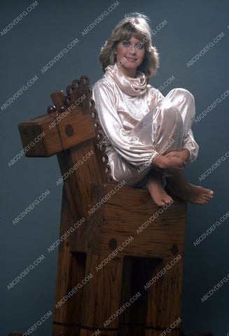 Olivia Newton-John sitting on a rocking horse 35m-5475
