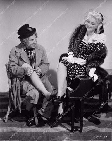 Harpo Marx compares legs with Marion Martin film The Big Store 3611-16