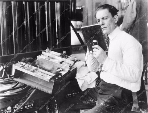 Lon Chaney Sr. testing his makeup skills with his box of tools 3949-33