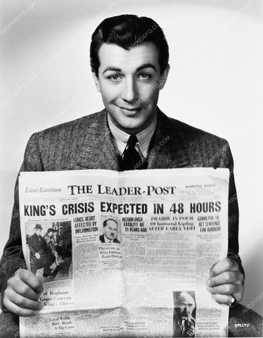 candid Robert Taylor reading the paper The Leader-Post between takes 4395-10