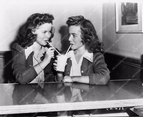 candid Shirley Temple and her stand in sharing a milk shake 4439-16