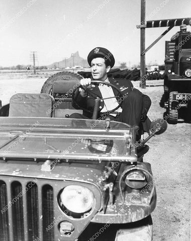 candid Robert Taylor sitting in a Jeep on set film Above and Beyond 4472-09
