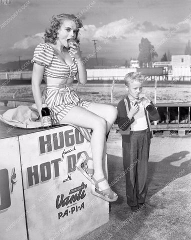 Marie Wilson enjoys an apple and Pepsi-Cola between races 45bx02-82