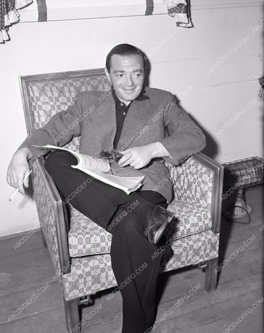 candid Peter Lorre relaxes while going over the script 4b09-036