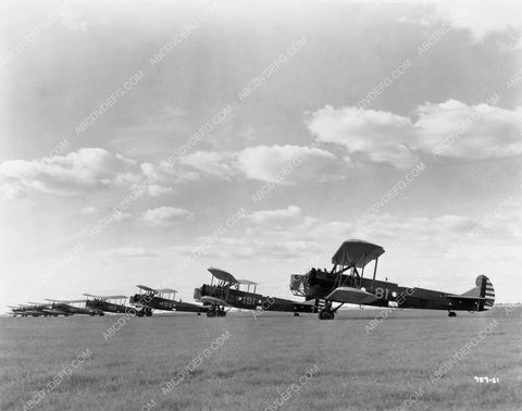 aviation later model bi-planes lines up on grass runway 4b09-435