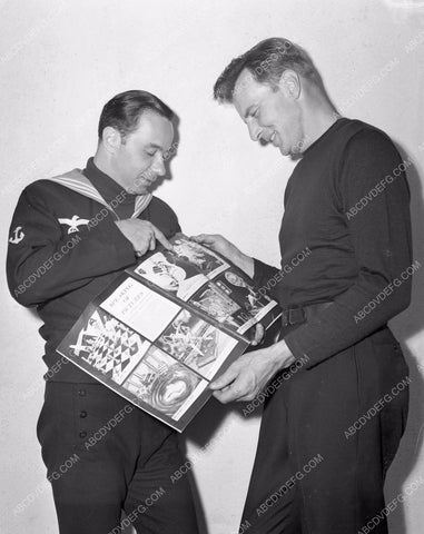 Bruce Bennett looks at scrapbook behind the scenes 4b09-519