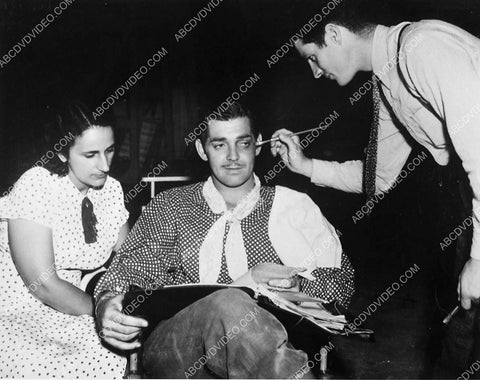 candid Clark Gable gets makeup while reading the script 5253-17