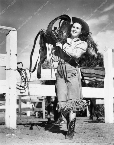 Deanna Durbin goes cowgirl look with saddle over shoulder to boot 6141-15