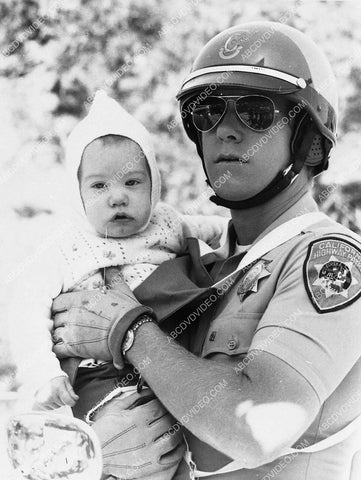 Larry Wilcox holding a baby TV Chips 6244-16