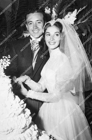 Vic Damone and wife Pier Angeli cutting their wedding cake 6851-019