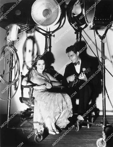 Maureen O'Sullivan entertained by Eddie Quillan under the cleeg lights 8245-36