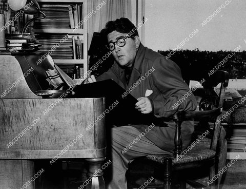 music composer and playwright Meredith Wilson sitting at his desk 8668-34