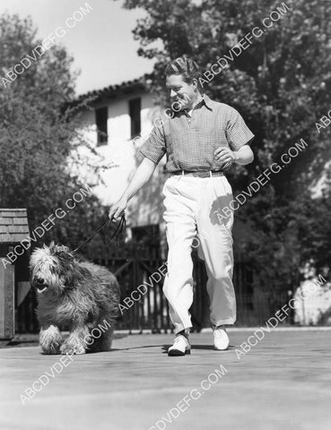 Nelson Eddy at home playing w his dog 8B11-752