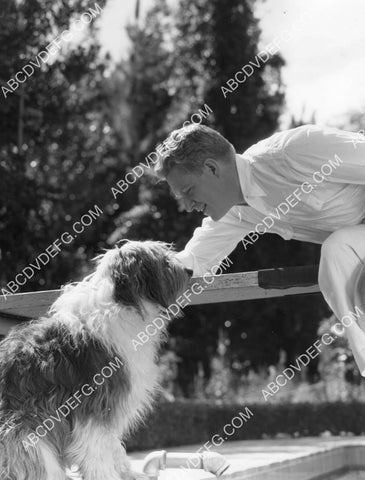 Nelson Eddy at home playing w his dog 8B11-758