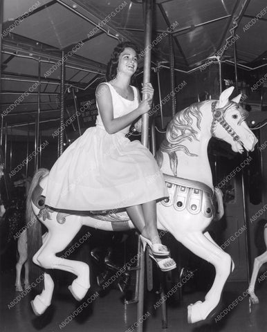 some cute girl takes ride on old merry-go-round carousel 8b6-100