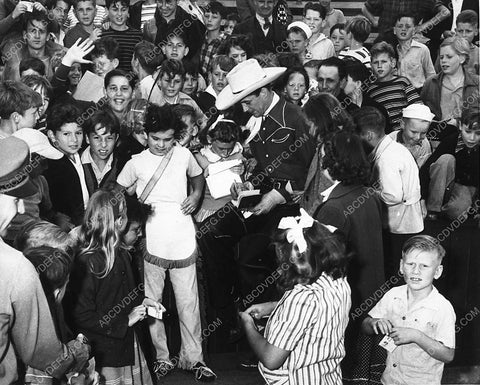 candid news photo Reed Hadley in cowboy garb signing autographs for the kids 9150-30
