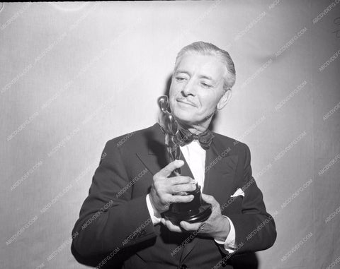 1947 Oscars Ronald Colman admiring his statue Academy Awards aa1947-20</br>Los Angeles Newspaper press pit reprints from original 4x5 negatives for Academy Awards.