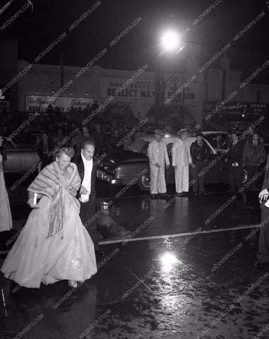 1952 Oscars Darryl Zanuck and wife try to beat rain Academy Awards aa1952-31</br>Los Angeles Newspaper press pit reprints from original 4x5 negatives for Academy Awards.