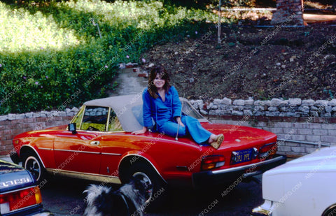 Dawn Lynn Garrett sister of Leif sits on new car waits for dog 8b20-0371