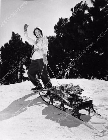 Maureen O'Sullivan hauls Christmas presents through snow on sled 8b20-0476