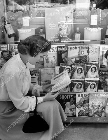 candid Colleen Townsend makes a selection at the magazine rack 8b20-10841