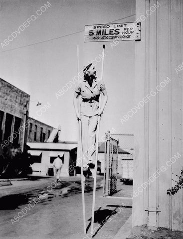 Lucilla Ball walks around RKO Studios backlot on stilts 8b20-14114