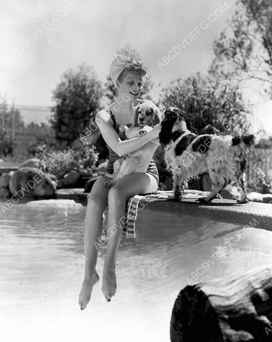 Lucille Ball plays w her dogs by the pool in the backyard 8b20-14123
