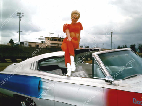 Diane McBain sitting on racecar pace car at the racetrack 8b20-14672