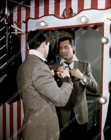 Cary Grant adjusts his tie in the mirror 8b20-14701