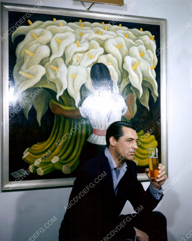 Cary Grant sitting in front of some art 8b20-14707